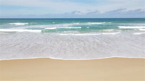 Aerial View Of Sand Beach And Water Surface Texture Foamy Waves With Sky Beautiful Tropical