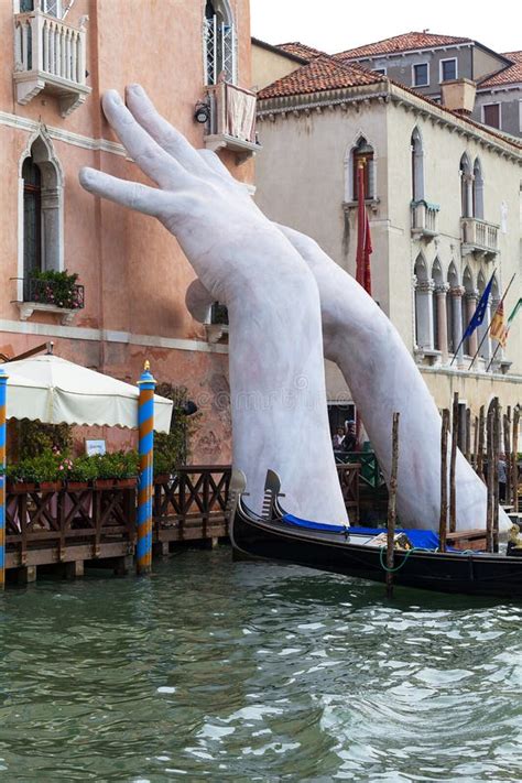 Support Sculpture By Lorenzo Quinn Putting Two Giant Hands Protruding