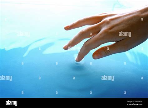 Finger Touches Water Close Up Stock Photo Alamy