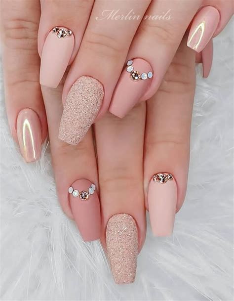 Some Pink And Gold Nail Designs On Someone S Nails With White Glitter