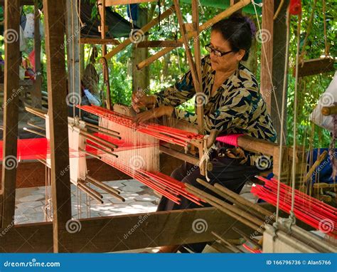 A Female Weaver Producing Silk Fabric On A Traditional Hand Loom On