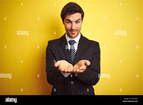 Young Handsome Businessman Wearing Suit And Tie Standing Over Isolated