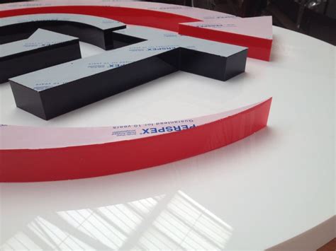 The Letters E And F Are On Display In Front Of A Circular White Table