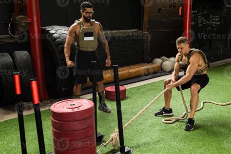 Sled drag exercise. Sportsman during his cross training workout ...