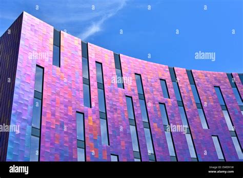 Abstract Pattern Of Colourful Cladding And Glazing Panels Reflecting Light From Bright Sky On