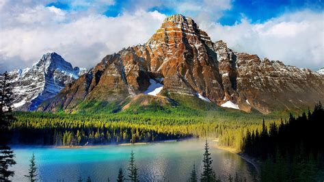 Landscape View Of Brown White Covered Mountains Trees Forest River Under White Clouds Blue Sky ...