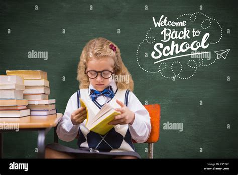 Composite Image Of Blonde Pupil Reading A Book Stock Photo Alamy