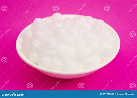 Bowl Of Popping Boba Pearls On A Bright Pink Background Stock Photo