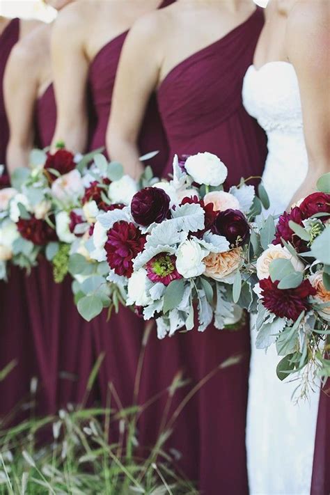 The Bridesmaids Are Holding Their Bouquets With Red And White Flowers