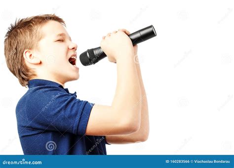 Teenage Boy Singing Into A Microphone Very Emotional Stock Photo