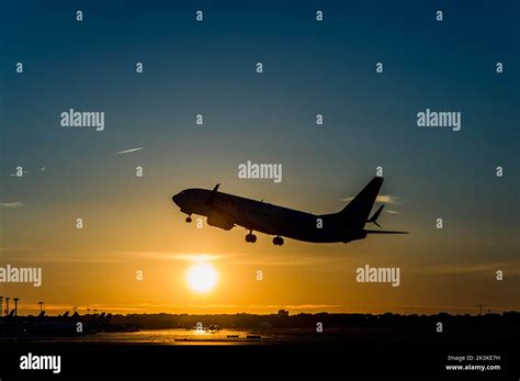 Plane taking off at sunset Stock Photo - Alamy