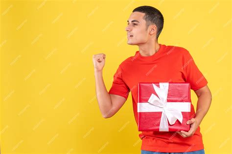 Free Photo Front View Of Young Man Holding Present Rejoicing On