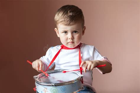 Little Boy Playing The Drum Child Development Concept Stock Image