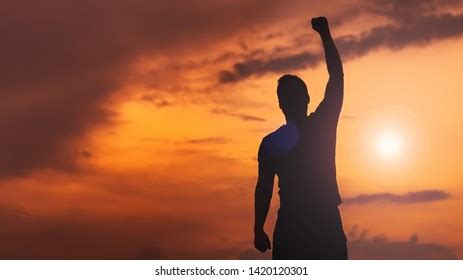 Silhouette Man Hands Raised Sunset Empowered Stock Photo