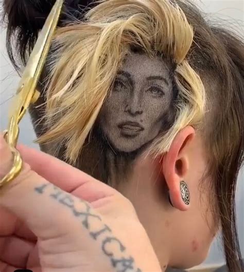 A Woman With Her Hair Pulled Back And Tattoos On Her Face Is Cutting