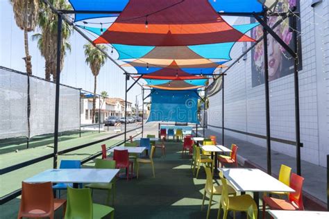 Colorful Fabric Shades On Outdoor Restaurant With Chairs And Tables
