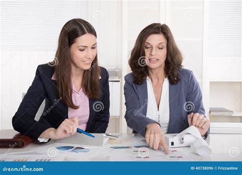 Two Business Woman Analyzing Balance Sheet Stock Photo Image Of Blue