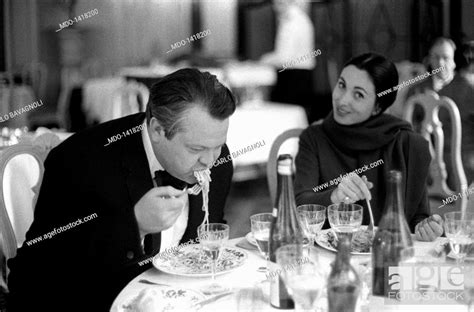 Orson Welles And Paola Mori Having Lunch At Table The Us Film Director