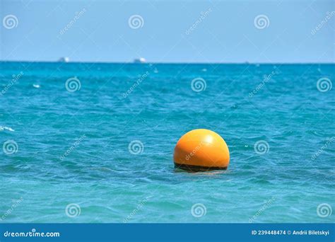 Yellow Buoy Floating On Sea Surface As Marker For Swimming Restriction