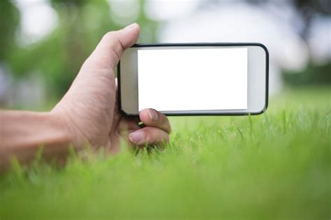 Premium Photo Close Up Man Hand Using Smartphone In Green Park