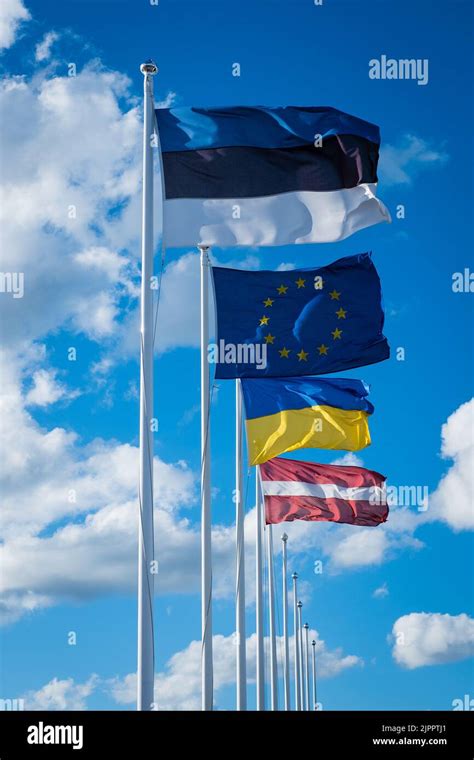 Flags Of Estonia European Union Ukraine And Latvia Waving In Wind