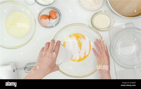 Egg Yolks And Sugar Close Up In A Glass Bowl Step By Step Baking