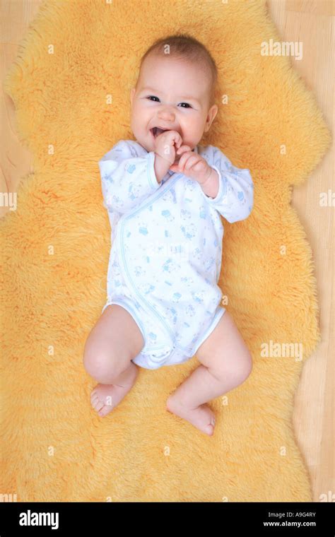 Baby Lying On A Sheepskin Rug Stock Photo Alamy