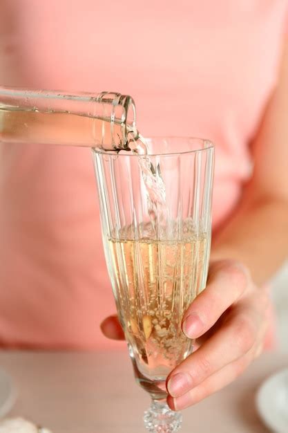 Premium Photo Woman Pouring Wine Into Glass Close Up