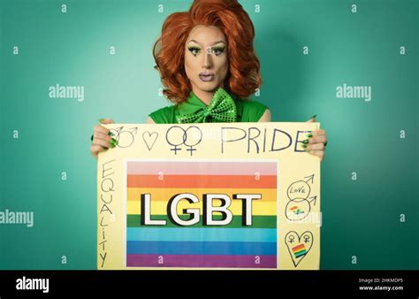 Drag Queen Celebrating Gay Pride Holding Banner With Rainbow Flag