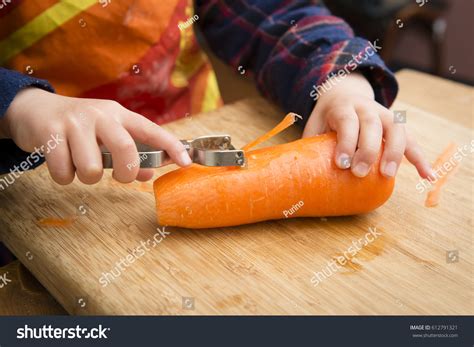 Kid Peeling Carrot Over 213 Royalty Free Licensable Stock Photos