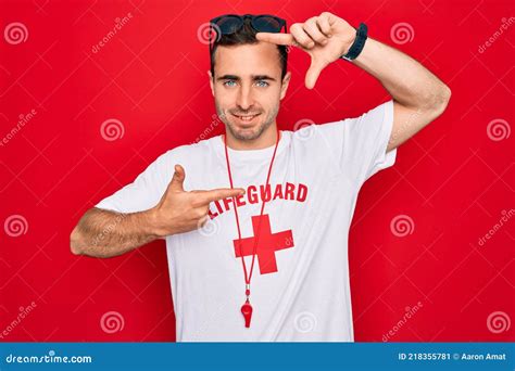 Handsome Lifeguard Man Wearing T Shirt With Red Cross And Whistle Over