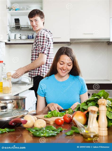 Woman Cooking Food While Man Washing Dishes Stock Photo Image Of