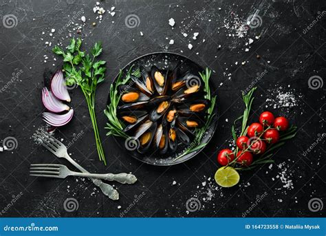 Mussels With Spices And Rosemary Seafood On Black Background Stock