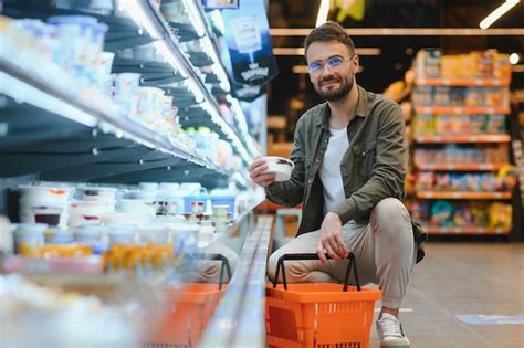 Premium Photo Handsome Man Buying Some Healthy Food And Drink In Modern Supermarket Or Grocery