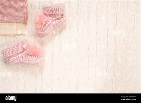 Pink Knitted Socks And Romper On White Background Copy Space Baby