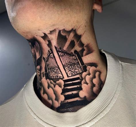 A Mans Neck With A Gate And Clouds Tattoo On The Back Of His Neck
