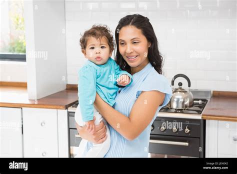 Smiling Brunette Holding Her Baby Stock Photo Alamy