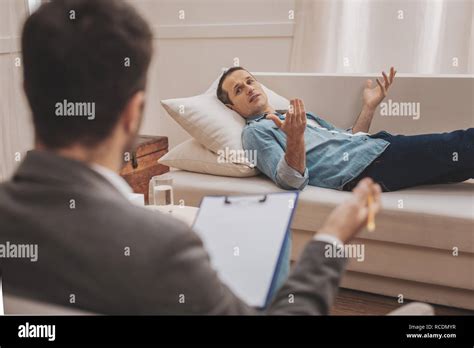 Man Lying On Sofa Therapist Hi Res Stock Photography And Images Alamy