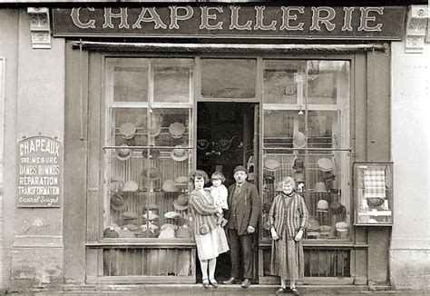 Three People Standing In Front Of A Shop Window