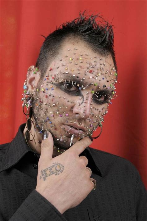 a man with makeup and piercings on his face