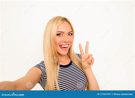 Comic Selfie Of Playful Girl Showing Tongue And Two Fingers Stock Image