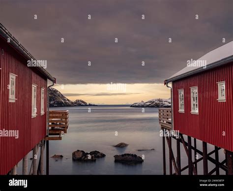 View Between Two Traditional Red Wooden Houses Across The Fjord To The