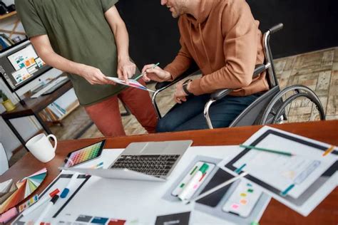 Brainstorming Cheerful Male UX UI Designer In A Wheelchair Holding A