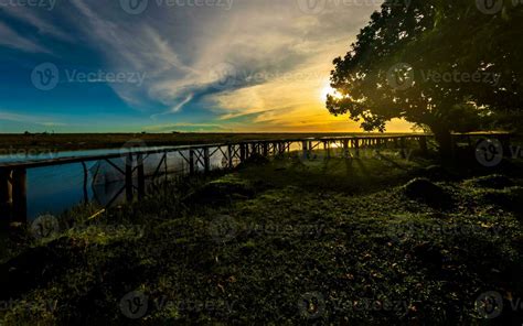 Beautiful sunset landscape with wooden bridge 25872455 Stock Photo at Vecteezy