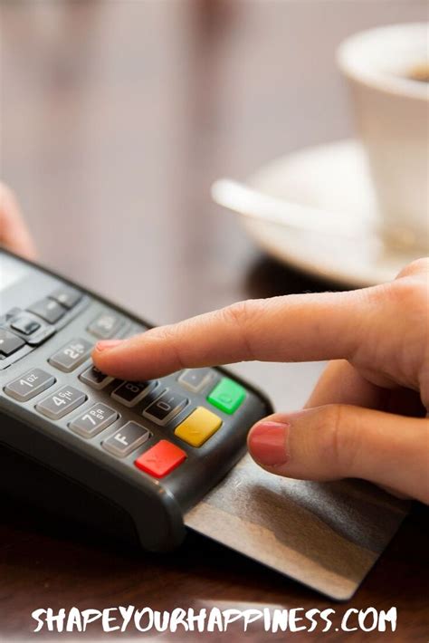 A Person Using A Credit Card Machine To Pay For Some Coffee Or Tea At A