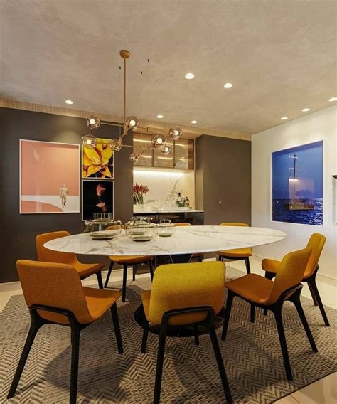 A Dining Room Table With Yellow Chairs Around It