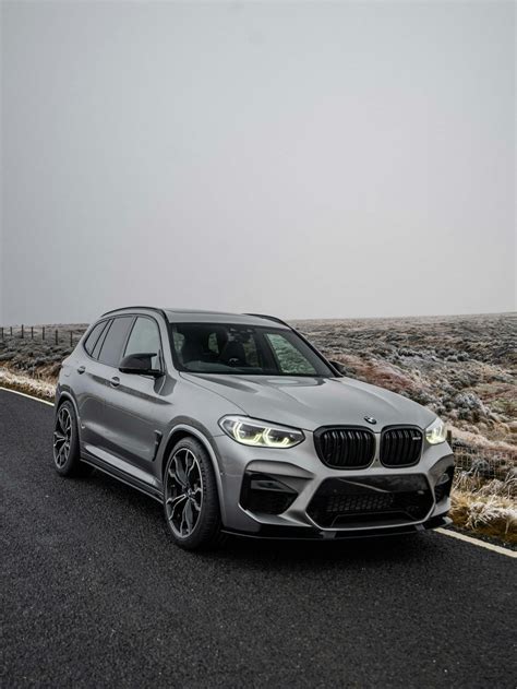 A silver bmw suv driving down a road photo – Free Grey Image on Unsplash