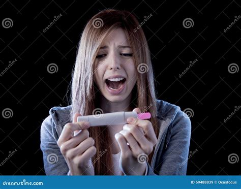 Young Woman Scared And Shocked Holding Pregnancy Test Positive Result