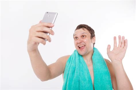 Premium Photo The Guy Takes A Selfie After Morning Procedures A Man Looks At The Phone Camera