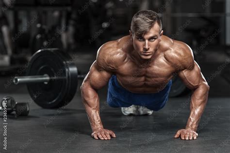 Muscular Man Working Out In Gym Doing Push Ups Exercises Strong Male